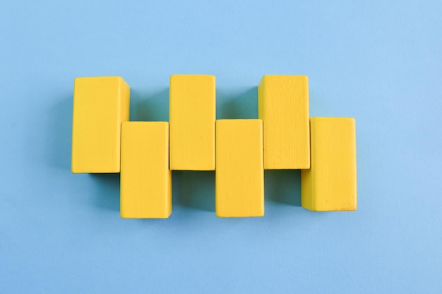 Yellow wooden cube blocks isolated on a yellow background