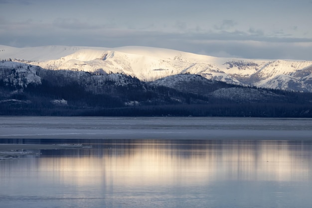Yellowstone lake with snow covered mountains in american landscape