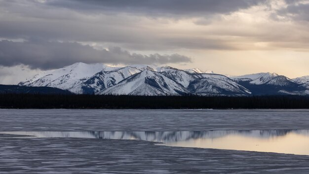 Yellowstone lake with snow covered mountains in american landscape