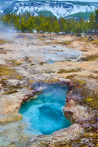 Yellowstone in winter with deep blue thermal pools