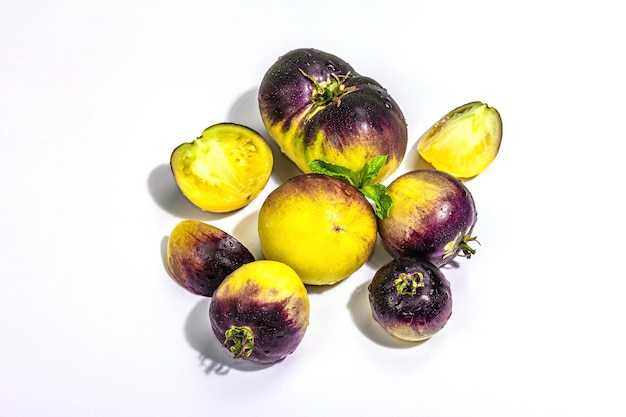 Yellowviolet Tomatoes variëteit Primaire kleuren geïsoleerd op witte achtergrond
