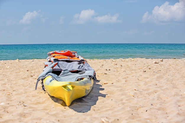 Yelow kayak on sandy beach The concept of active rest