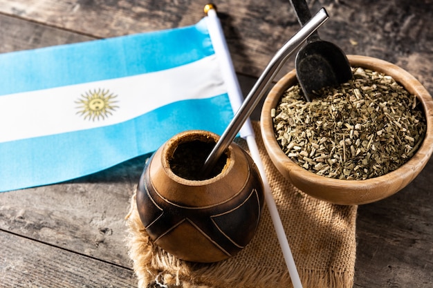 Premium Photo  Yerba mate tea and argentina flag on wooden table with copy  space. traditional argentinian beverage