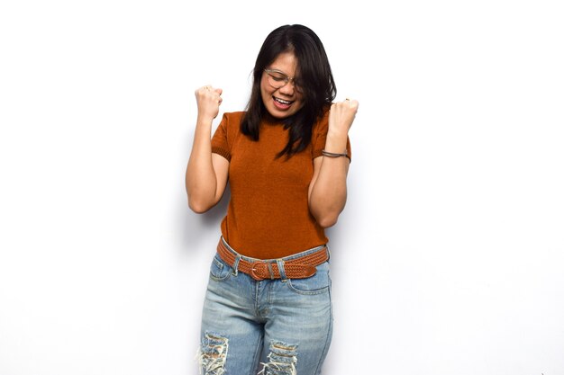 Yes or excited gesture of Young beautiful asian women dress orange shirt isolated on white