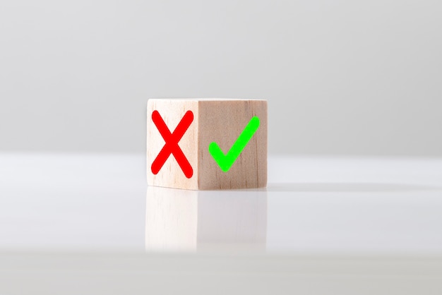 Yes or No symbols on wood blogs cube on light background. The concept of choice and making the right decision.