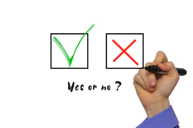 Photo yes no tickbox with green red tick. hand holding marker isolated on white boards