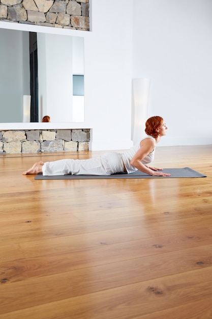 Фото Йога упражнения в деревянный пол тренажерный зал и зеркало