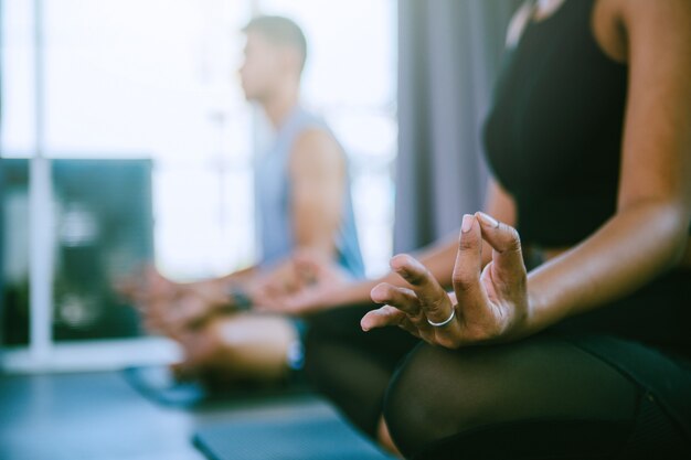 Yoga group concept; young people practicing yoga in class; feeling Calmness and relax in yoga class