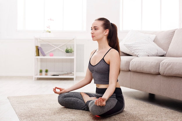 Yoga at home woman do lotus pose