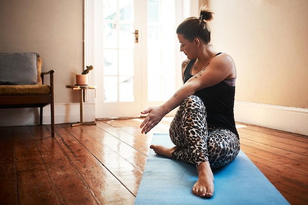 Yoga keeps me in the best shape Shot of a young woman exercising at home