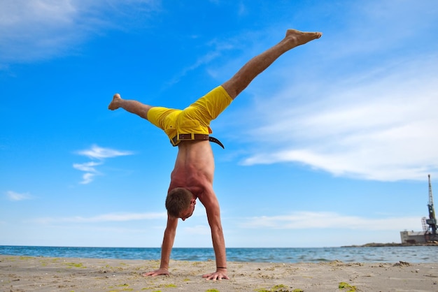 Yoga man standing on hands