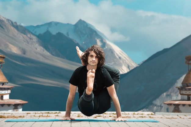 Yoga man Young man doing yoga in loft on sunrise