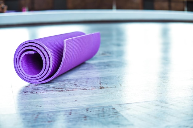 The yoga mat is on the floor in the gym Yoga fitness and sports equipment