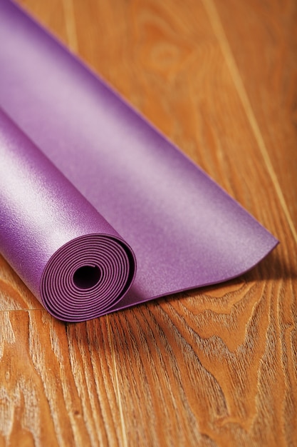 yoga mat is twisted on the wooden floor