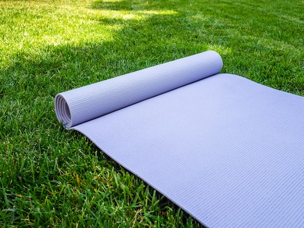 Yoga Mat, Pilates or fitness on green lawn. Training in fresh air