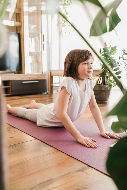 Yoga poses for kids girl learning yoga at home online sports life style sports in childrens live