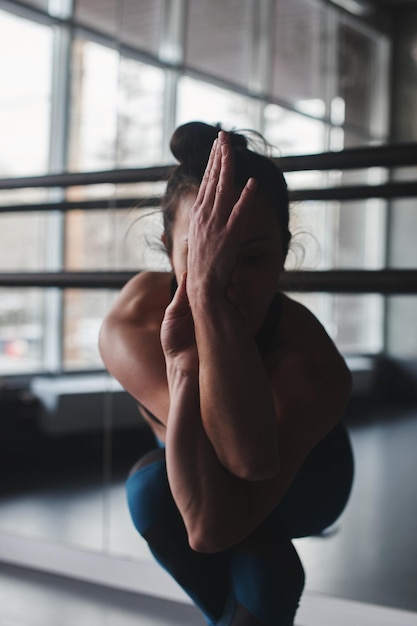 Yoga. Woman doing exercises in the gym