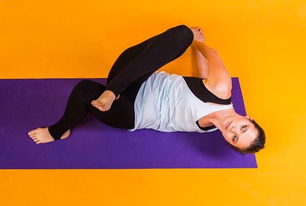 Yoga woman exercising on mat