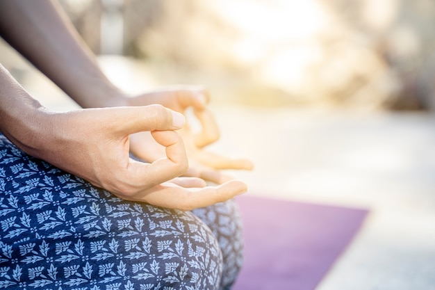 Yoga woman meditating at sunset. Female model meditating in serene harmony