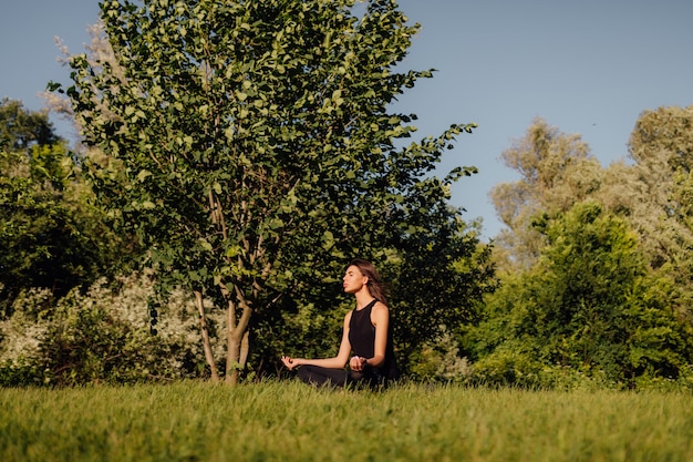 Yoga woman in meditation pose healthy lifestyle outdoors