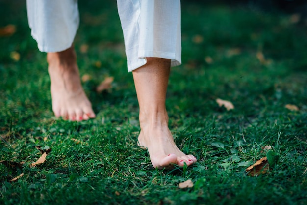 Yoga Woman Walking barefoot focus on feet