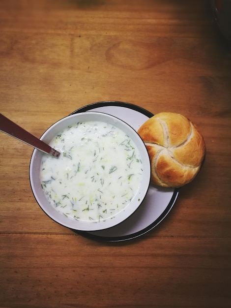 yoghurt with bread served on table