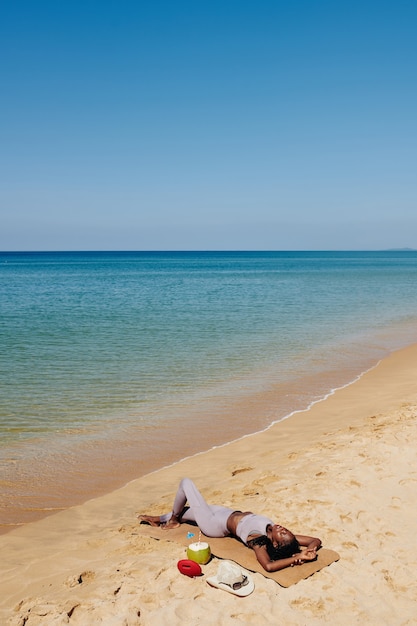 Yogi sunbathing on beach