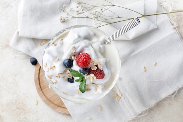 Yogurt dessert with oatmeal, blueberries, raspberry and mint