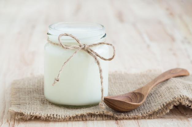 Yogurt in glass bottles on wooden table