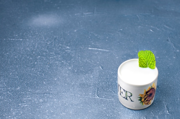 yogurt in a glass with mint and a gray background