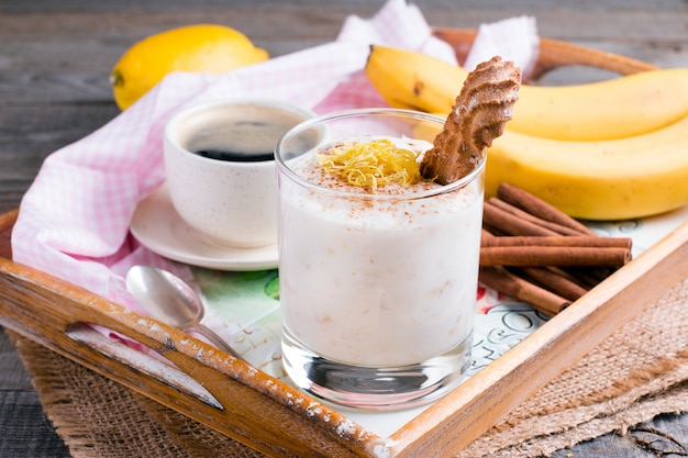 Yogurt with banana on a wooden background