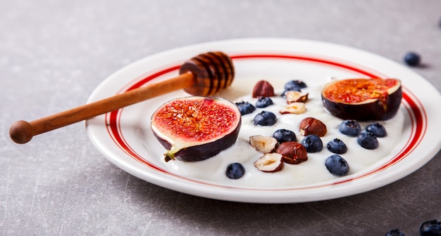 Yogurt with berries fresh figs, blueberries and honey