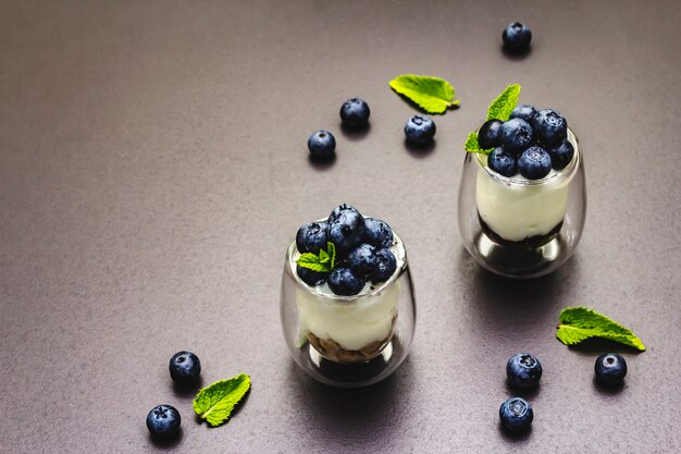 Yogurt with blueberries and chia seeds on cutting board