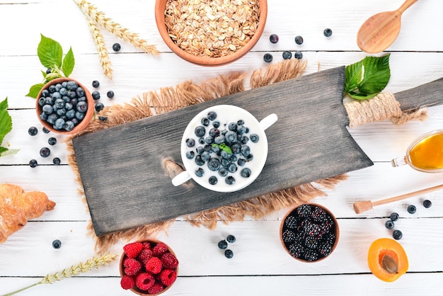 Yogurt with Blueberry Breakfast On a wooden background Top view Free space for text