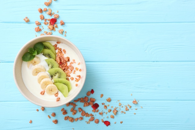 Yogurt with fruits granola and nuts on the table top view