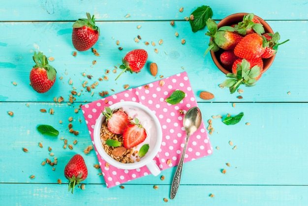 Yogurt with granola, nuts and fresh strawberry