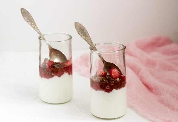 Yogurt with granola and strawberries.