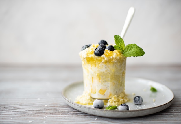 Yogurt with mango and blueberries in a cup