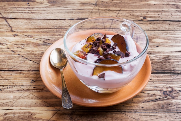 yogurt with muesli and berries in small glass.