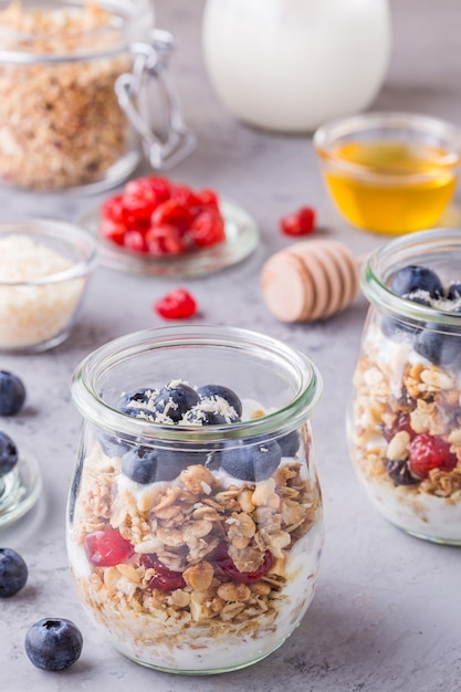 Yogurt with oat flakes and fresh fruit in jars