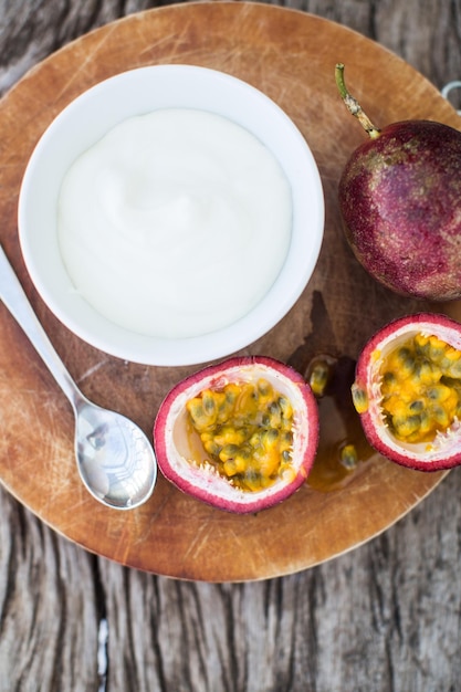 Yogurt with passion fruit in a white bowl