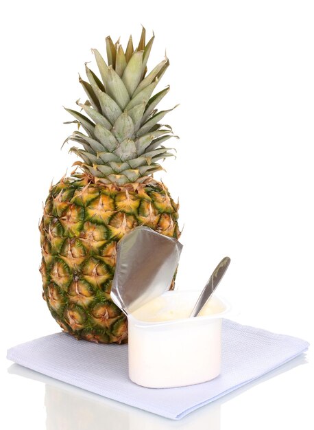 Yogurt with pineapple isolated on white