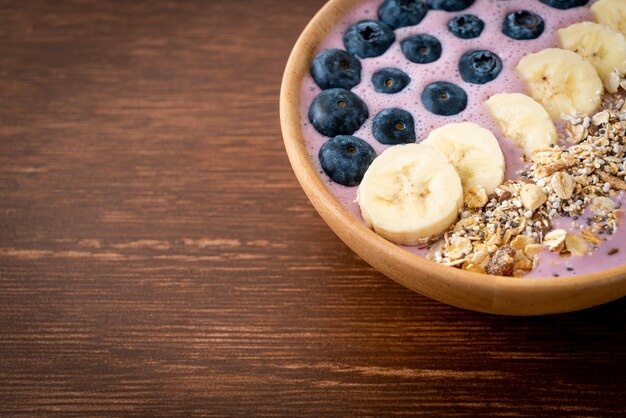 Yogurt or yoghurt smoothie bowl with blue berry banana and granola