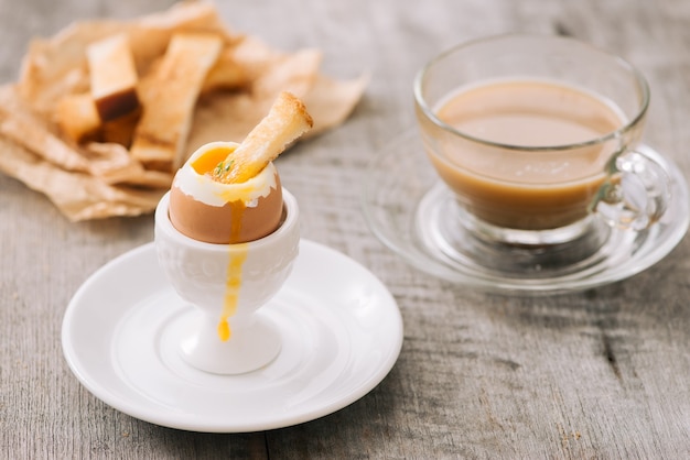 The yolk flows from boiled egg on toast