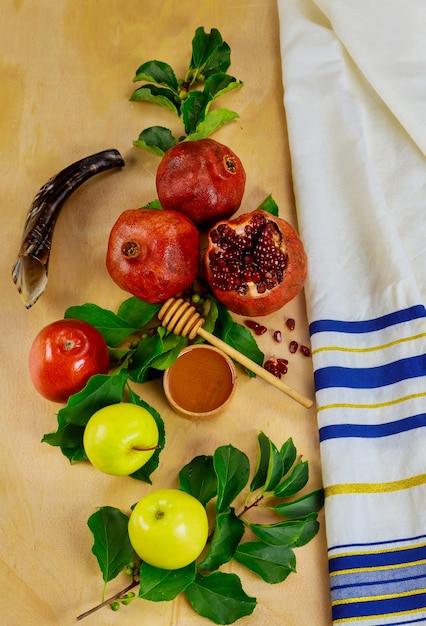 Yom Kippur concept. Fruits with honey and jewish prayer tallit.