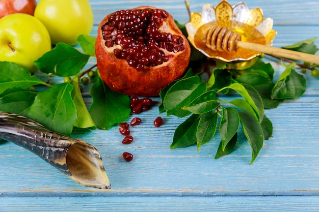 Yom Kippur jewish hiliday concept. Food and horn on blue table.