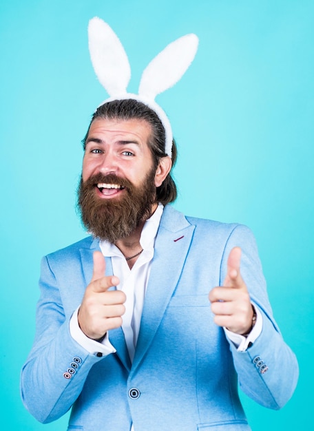 You are next celebration concept brutal handsome man with moustache mature guy wear rabbit ears happy easter spring holiday and party funny bearded hipster in bunny ears