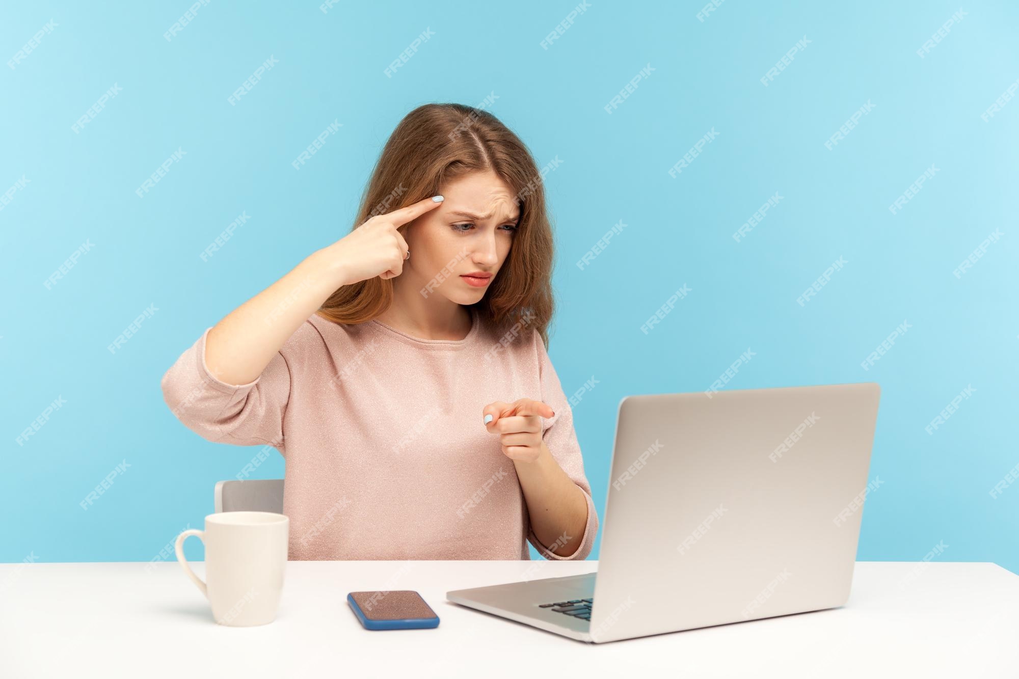 Premium Photo  You are idiot angry woman at workplace making stupid  gesture and pointing to laptop screen having silly senseless talk on video  call accusing dumb mind indoor studio shot isolated