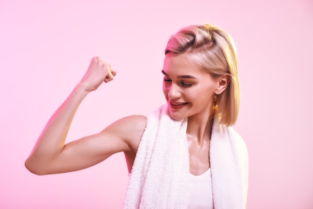 You are stronger than you think attractive young sporty woman showing her bicep and smiling