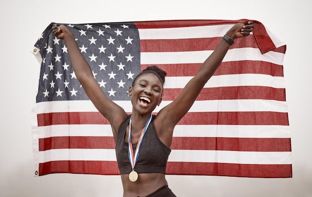 You can congratulate me now. Shot of a young female athlete celebrating her win while running with a flag.